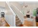 Open-concept living area with hardwood floors, fireplace, and abundant natural light from large windows at 164 Stoneforest Dr, Woodstock, GA 30189