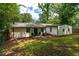 Exterior of the home surrounded by luscious green trees and grass at 1819 Waldrep Se Cir, Marietta, GA 30060