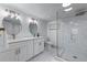 Bathroom with dual vanities, marble tiling, and seamless glass shower at 1819 Waldrep Se Cir, Marietta, GA 30060