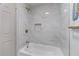 Bright bathroom featuring tiled walls, a tub, and gold shower fixtures at 1819 Waldrep Se Cir, Marietta, GA 30060