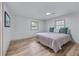 Bedroom with light wood floors, two windows, and a comfy bed at 1819 Waldrep Se Cir, Marietta, GA 30060