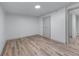 Bright bedroom with wood floors, white walls, closet, and a door for a clean and modern aesthetic at 1819 Waldrep Se Cir, Marietta, GA 30060