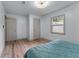 A bright bedroom featuring wood floors, white walls, closet, and a window for natural light at 1819 Waldrep Se Cir, Marietta, GA 30060
