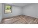 Bright bedroom featuring wood floors, white walls, and a window for natural light at 1819 Waldrep Se Cir, Marietta, GA 30060