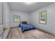 Sunlit bedroom with wood floors and comfortable blue bedding, showcasing tranquil living at 1819 Waldrep Se Cir, Marietta, GA 30060