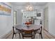 Open dining room with modern light fixture, seamlessly connected to kitchen at 1819 Waldrep Se Cir, Marietta, GA 30060