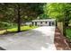 View of the home's exterior featuring a long driveway and mature trees at 1819 Waldrep Se Cir, Marietta, GA 30060
