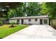Charming single-story home features a well-manicured lawn and a concrete driveway at 1819 Waldrep Se Cir, Marietta, GA 30060