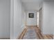 A neutral hallway with wood floors and a modern rug, offering a clean transition at 1819 Waldrep Se Cir, Marietta, GA 30060