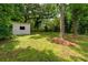 White shed with a window and door surrounded by mature trees at 1819 Waldrep Se Cir, Marietta, GA 30060