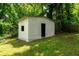 Close up of a white shed with a window and door surrounded by trees at 1819 Waldrep Se Cir, Marietta, GA 30060