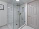 Close up of a marble tiled shower featuring gold hardware and seamless glass doors at 1819 Waldrep Se Cir, Marietta, GA 30060