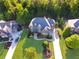 An aerial view of a luxury home and landscaped yard with a well manicured lawn and long driveway at 2325 Manor Creek Ct, Cumming, GA 30041