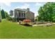 Expansive backyard view features a screened porch, swimming pool, and lush landscaping at 2325 Manor Creek Ct, Cumming, GA 30041