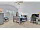 Cozy bedroom with a vaulted ceiling, featuring a twin bed, large window, a ceiling fan, and neutral-colored carpet at 2325 Manor Creek Ct, Cumming, GA 30041