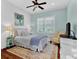 Bedroom with board and batten accent wall, ceiling fan and many windows at 2325 Manor Creek Ct, Cumming, GA 30041