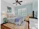Bedroom with board and batten accent wall, ceiling fan and many windows at 2325 Manor Creek Ct, Cumming, GA 30041