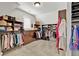 Spacious walk-in closet with custom shelving and hanging rods provides ample storage and organization at 2325 Manor Creek Ct, Cumming, GA 30041