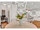 Bright dining area with stylish light fixture is situated adjacent to a modern kitchen at 2325 Manor Creek Ct, Cumming, GA 30041