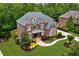 Beautiful brick home with manicured lawn, lush landscaping, and classic architectural details at 2325 Manor Creek Ct, Cumming, GA 30041