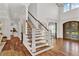 Open concept foyer with wooden staircase and double doors at 2325 Manor Creek Ct, Cumming, GA 30041