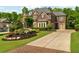 Beautiful brick home with lush landscaping and a brick-lined driveway at 2325 Manor Creek Ct, Cumming, GA 30041