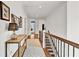 Bright hallway featuring hardwood floors, white walls, and decorative lighting, leading to other rooms in the home at 2325 Manor Creek Ct, Cumming, GA 30041