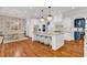 A modern kitchen offers hardwood floors, white cabinets, stainless appliances, and a large center island at 2325 Manor Creek Ct, Cumming, GA 30041