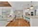 Spacious open-concept kitchen and living space features hardwood floors, white cabinets and large island at 2325 Manor Creek Ct, Cumming, GA 30041
