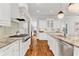 Bright, modern kitchen features hardwood floors, granite counters, white cabinets, and stainless appliances at 2325 Manor Creek Ct, Cumming, GA 30041