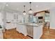 Open concept kitchen and living room offers hardwood floors, white cabinets, and granite countertops at 2325 Manor Creek Ct, Cumming, GA 30041