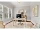 Home office with large windows, shutters, and hardwood floors at 2325 Manor Creek Ct, Cumming, GA 30041