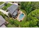 An aerial view showcases a backyard pool and hot tub with an outdoor kitchen and patio at 2325 Manor Creek Ct, Cumming, GA 30041