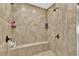Tiled shower with built-in bench seating and multiple shower heads, creating a spa-like experience at 2325 Manor Creek Ct, Cumming, GA 30041