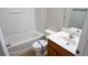 Bathroom featuring a white tub and shower, toilet with blue tape, and vanity with sink at 2476 Suwanee Pointe Dr, Lawrenceville, GA 30043