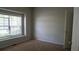 Bedroom with neutral walls, carpet flooring, and a window with blinds at 2476 Suwanee Pointe Dr, Lawrenceville, GA 30043