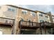 Townhome exterior with attached garage, deck, neutral color siding, and multi-pane windows at 2476 Suwanee Pointe Dr, Lawrenceville, GA 30043