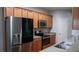 Well-lit kitchen featuring stainless steel appliances, granite countertops, and light wood cabinetry at 2476 Suwanee Pointe Dr, Lawrenceville, GA 30043