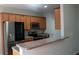 Modern kitchen featuring granite counters, stainless appliances, and wood cabinets at 2476 Suwanee Pointe Dr, Lawrenceville, GA 30043