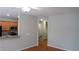 Living room with hardwood floors open to the kitchen and stairway at 2476 Suwanee Pointe Dr, Lawrenceville, GA 30043