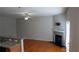 Open-concept living room and kitchen with hardwood floors and fireplace at 2476 Suwanee Pointe Dr, Lawrenceville, GA 30043