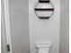 A minimalist powder room featuring a round wall shelf and a toilet at 2476 Suwanee Pointe Dr, Lawrenceville, GA 30043