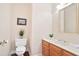 Powder room with vanity, toilet, neutral walls, and wood-look flooring at 3102 Royal Troon, Woodstock, GA 30189