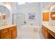 Primary bathroom with dual vanities, soaking tub, and glass-enclosed shower at 3102 Royal Troon, Woodstock, GA 30189
