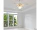 Bedroom with ceiling fan, neutral walls, and large windows overlooking greenery at 3102 Royal Troon, Woodstock, GA 30189