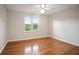 A bright bedroom with hardwood floors and a window with natural light at 3102 Royal Troon, Woodstock, GA 30189