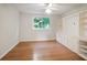 Bedroom with hardwood floors, built-in shelving and cabinets, and a large window at 3102 Royal Troon, Woodstock, GA 30189
