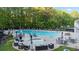 Community pool with lounge chairs, umbrellas, and tables for residents to relax at 3102 Royal Troon, Woodstock, GA 30189