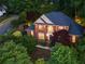 A classic brick home with a manicured lawn, stone accents, and a stately appearance at 3102 Royal Troon, Woodstock, GA 30189