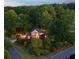A beautiful brick two-story home surrounded by lush landscaping and mature trees at 3102 Royal Troon, Woodstock, GA 30189